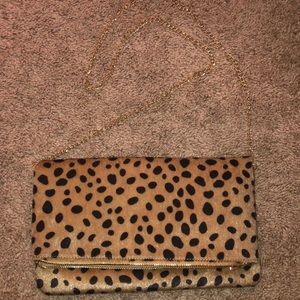 By fold leopard satchel